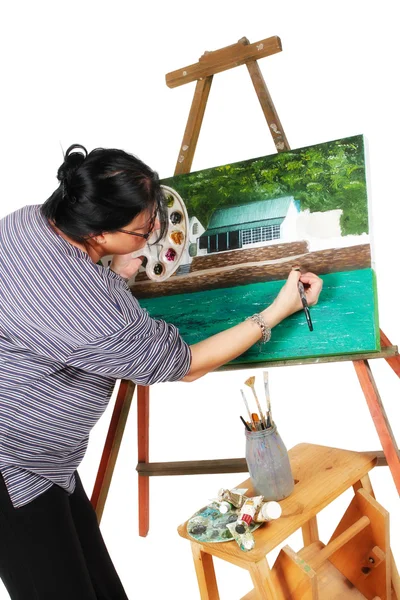 Женщина-художник рисует картину Стоковая Картинка