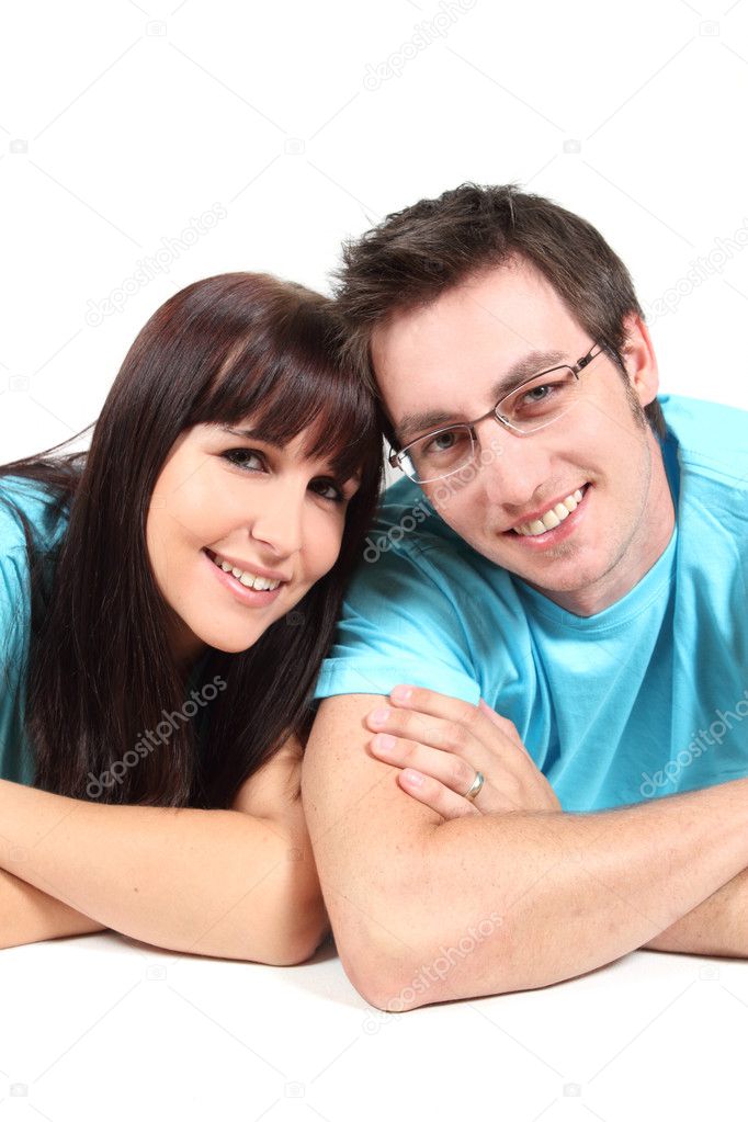 Young couple smiling on white background