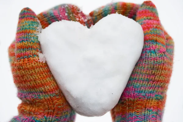 Heart of snow in gloves — Stock Photo, Image