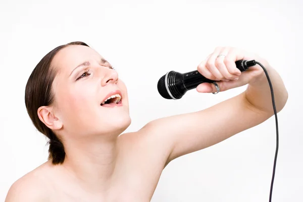 Singing woman with microphone — Stock Photo, Image