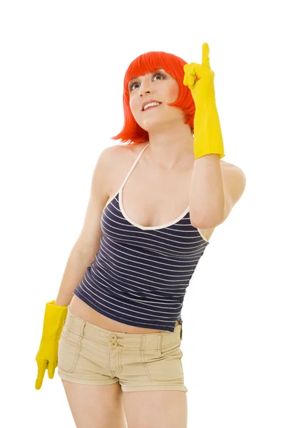 Woman in red wig and yellow gloves pointig with winger — Stock Photo, Image