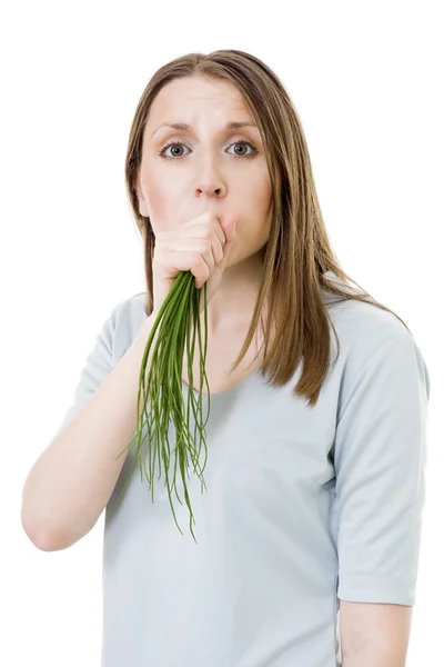 Woman eating bunch of onion — Stock Photo, Image