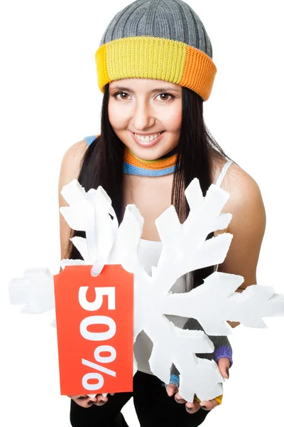 Vrouw houd sneeuwvlok met verkoop tag — Stockfoto