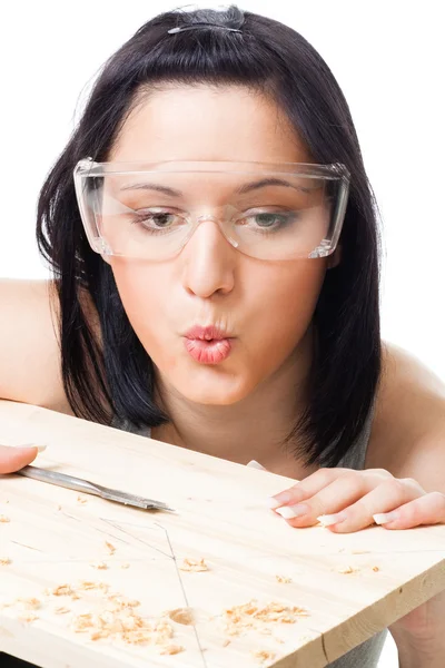 Woman blow away scobs after drilling — Stock Photo, Image
