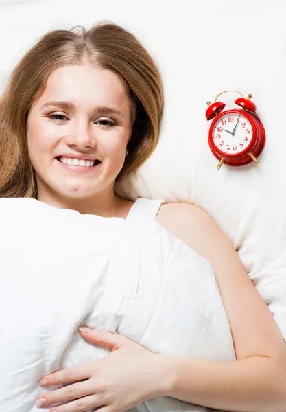 Woman lay on pillow with alarm — Stock Photo, Image