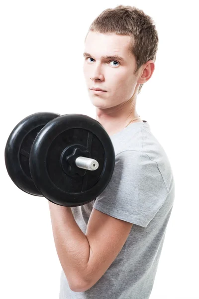 Koncentreret ung mand løft vægte - Stock-foto