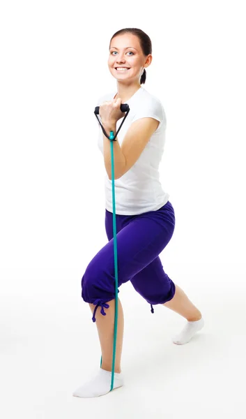 Mujer joven haciendo ejercicios con expansor — Foto de Stock
