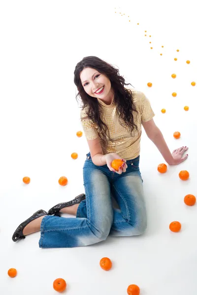 Tangerine fantasy - woman sit on a road of tangerine — Stock Photo, Image