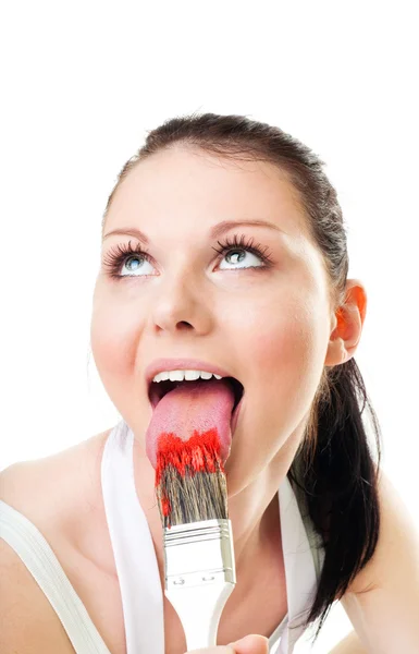 Woman lick paint brush for fun — Stock Photo, Image