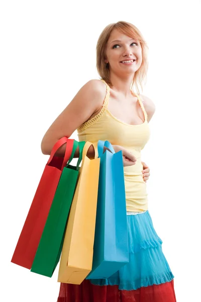 Menina sorridente com sacos coloridos — Fotografia de Stock