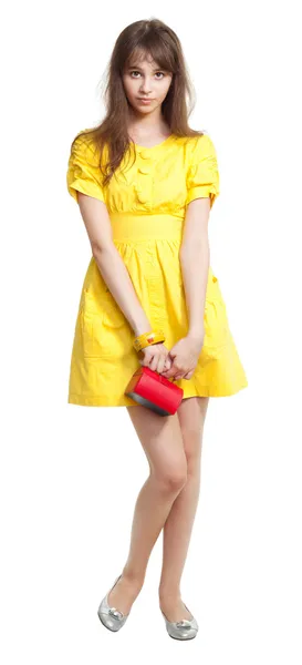 Girl in yellow with red purse — Stock Photo, Image