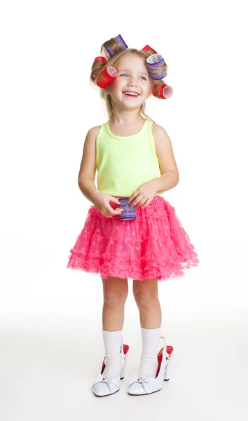 Little girl play fashion in mothers shoes and rollers — Stock Photo, Image