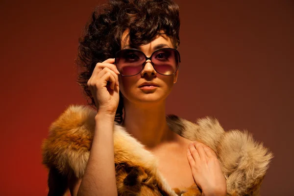 Woman wearing fur and glasses — Stock Photo, Image