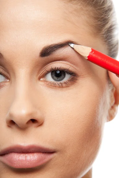 Pencil woman's eyebrows with a carpenters pen — Stock Photo, Image