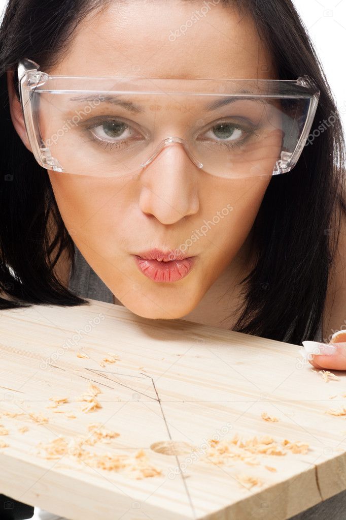 Woman carpenter blow away scobs
