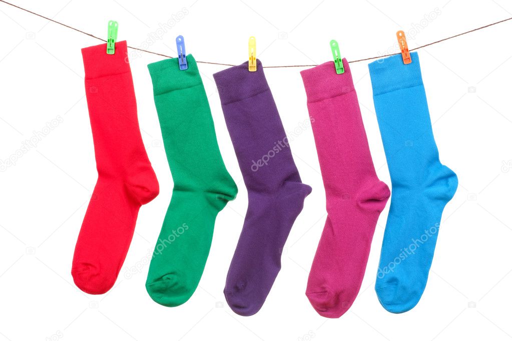 Five different color socks hang on rope