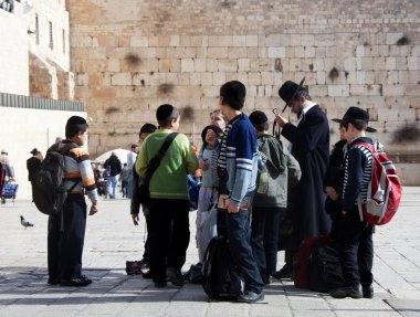 Group of Jewish children with Western wall on background clipart