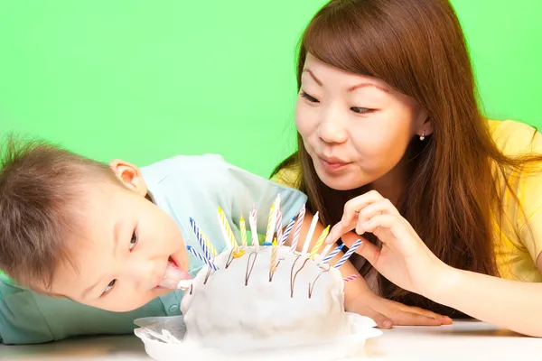 Boy licks his birthday cake — Stock Photo, Image