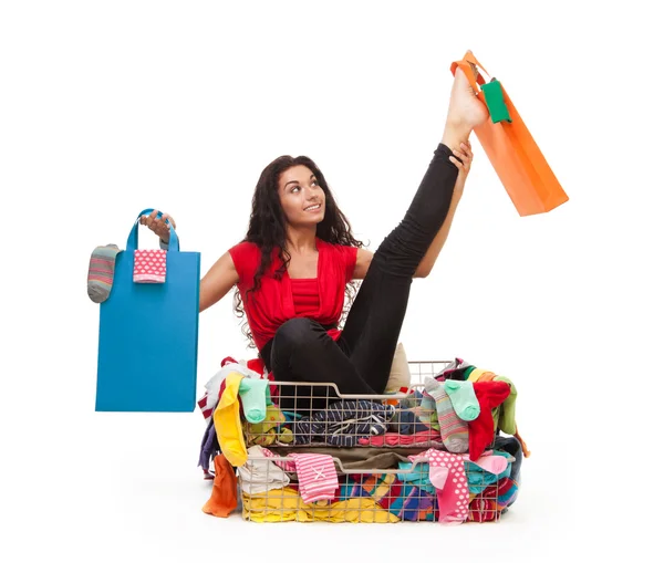 Woman in flexible pose with shopping bags — Stock Photo, Image