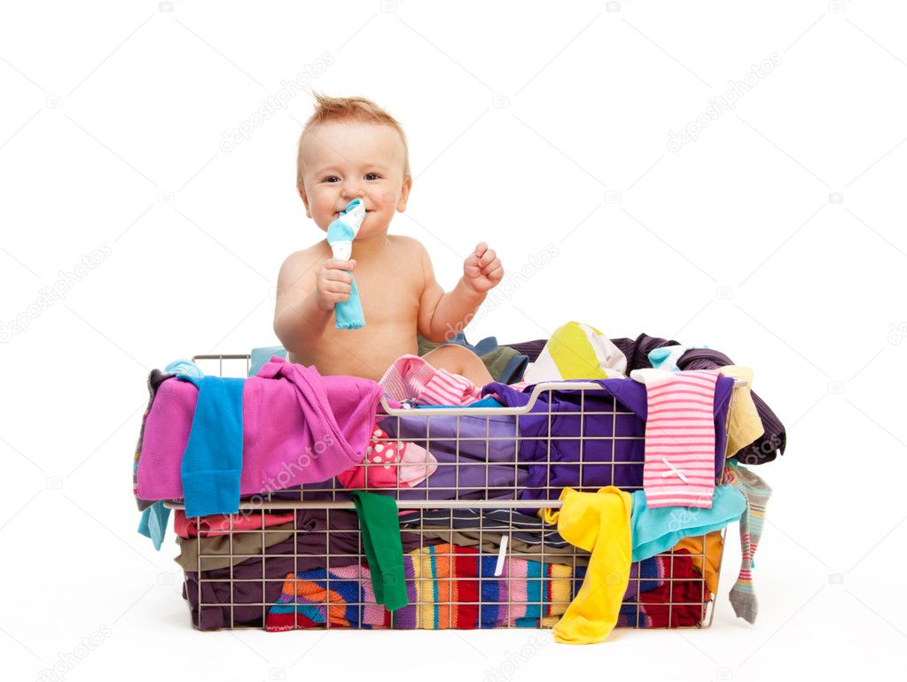 Toddler in basket with clothes