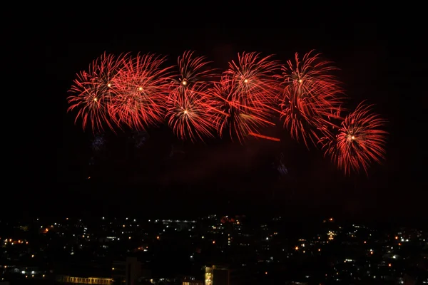 Red fireworks display over the town — Stock Photo, Image