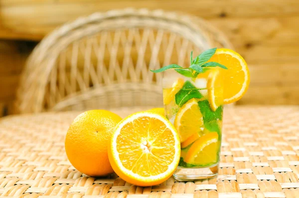 Glass of limonade with oranges — Stock Photo, Image