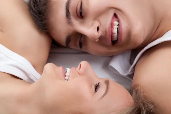 Paar liegt auf weißem Bett — Stockfoto