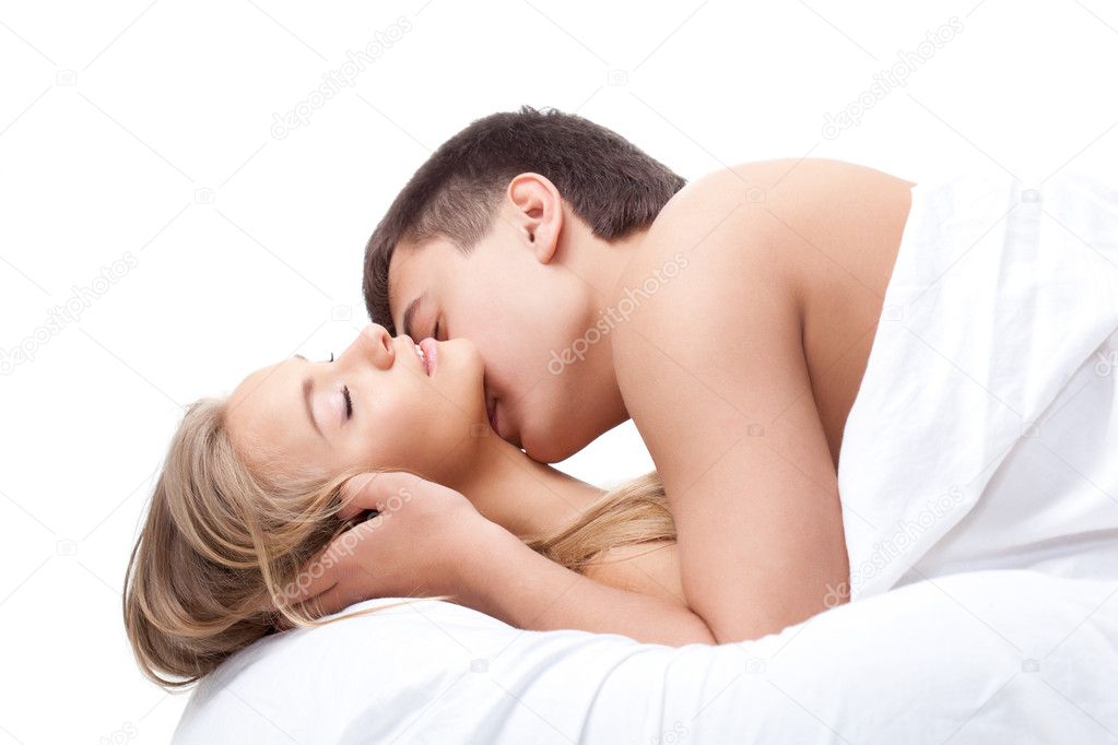 Couple lying on white bed