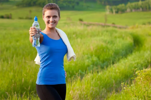 Sportovní žena drží voda — Stock fotografie