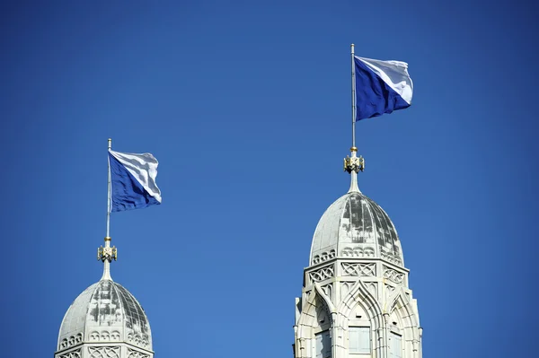 stock image Flagged steeple of Grossmunster, Zurich