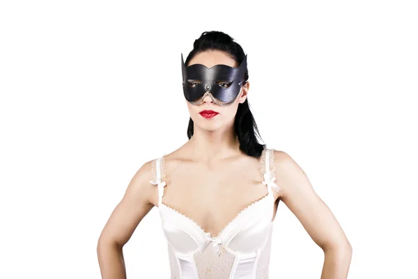 Een meisje in een zwarte masker en korset — Stockfoto