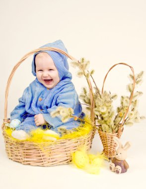 Funny child with easter eggs in basket clipart