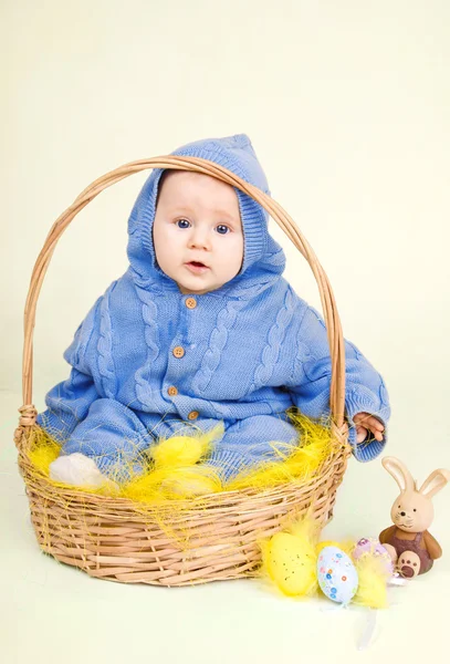 Funny child with easter eggs in basket — Stock Photo, Image