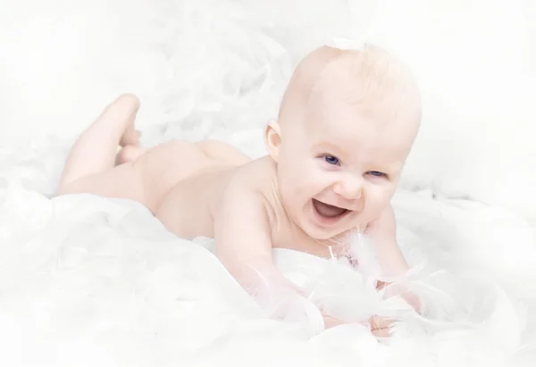 Portrait of happy baby with feather on white background — Stock Photo, Image