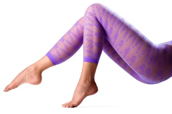 Female legs in purple leggings — Stock Photo, Image