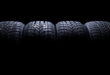 Car tires isolated on black background clipart
