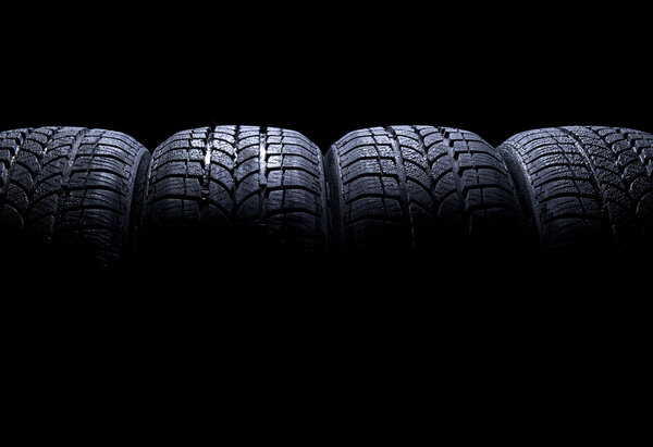Car tires isolated on black background