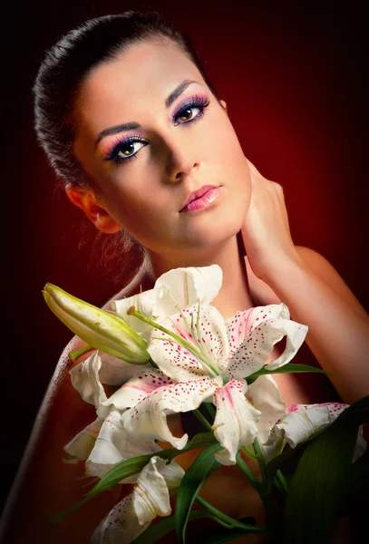 Beautiful young woman with white lily — Stock Photo, Image
