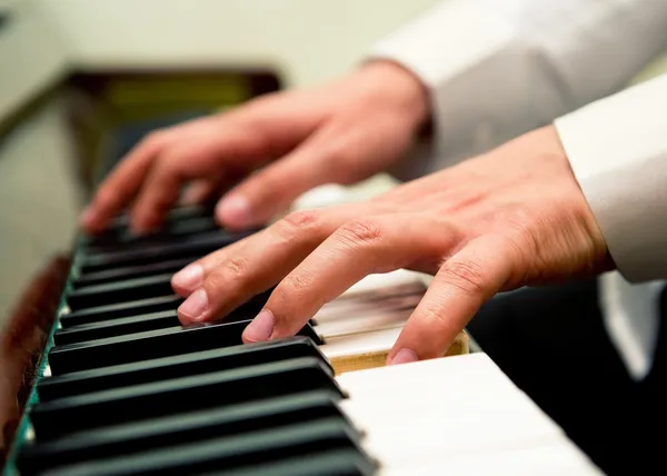 stock image Male hands playing the piano
