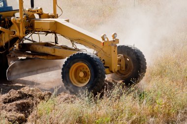 Road grader at work clipart