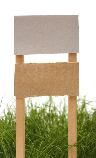 Cardboard sign with grass isolated on a white background — Stock Photo, Image