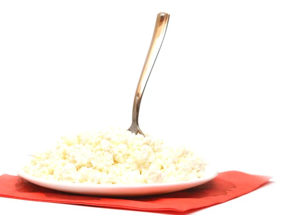 Heap of cottage cheese and spoon in white plate — Stock Photo, Image