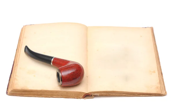 Opened empty old book with pipe — Stock Photo, Image