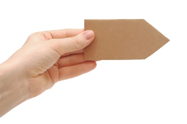 Cardboard arrow in a hand isolated on white — Stock Photo, Image