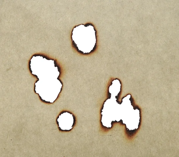 Holes burned in old paper — Stock Photo, Image