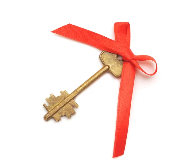 Old key with red ribbon — Stock Photo, Image