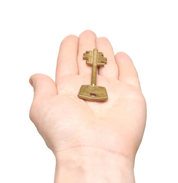 Starý klíč v ruce žena izolovaných na bílém pozadí — Stock fotografie