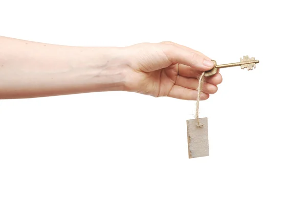 Mão e chave com etiqueta em branco isolada no fundo branco — Fotografia de Stock
