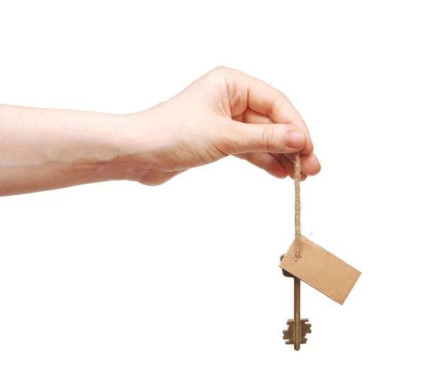 Hand och nyckel med tomma etiketten isolerad på vit bakgrund — Stockfoto