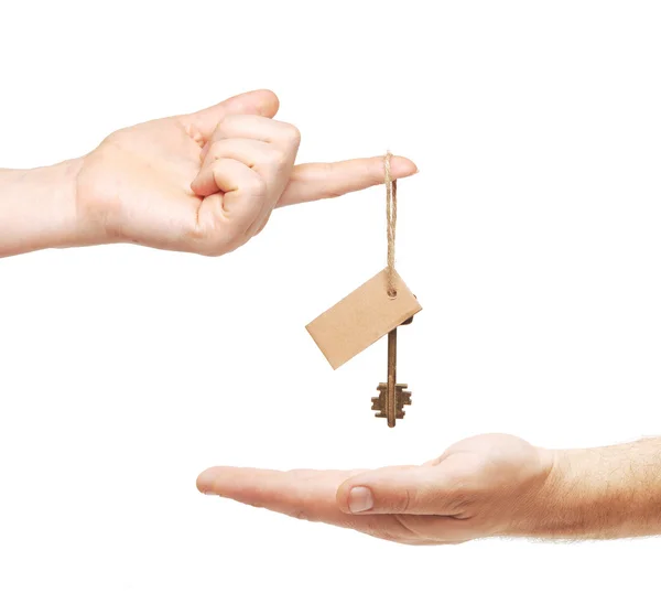 stock image Hands and key with blank label isolated on white background